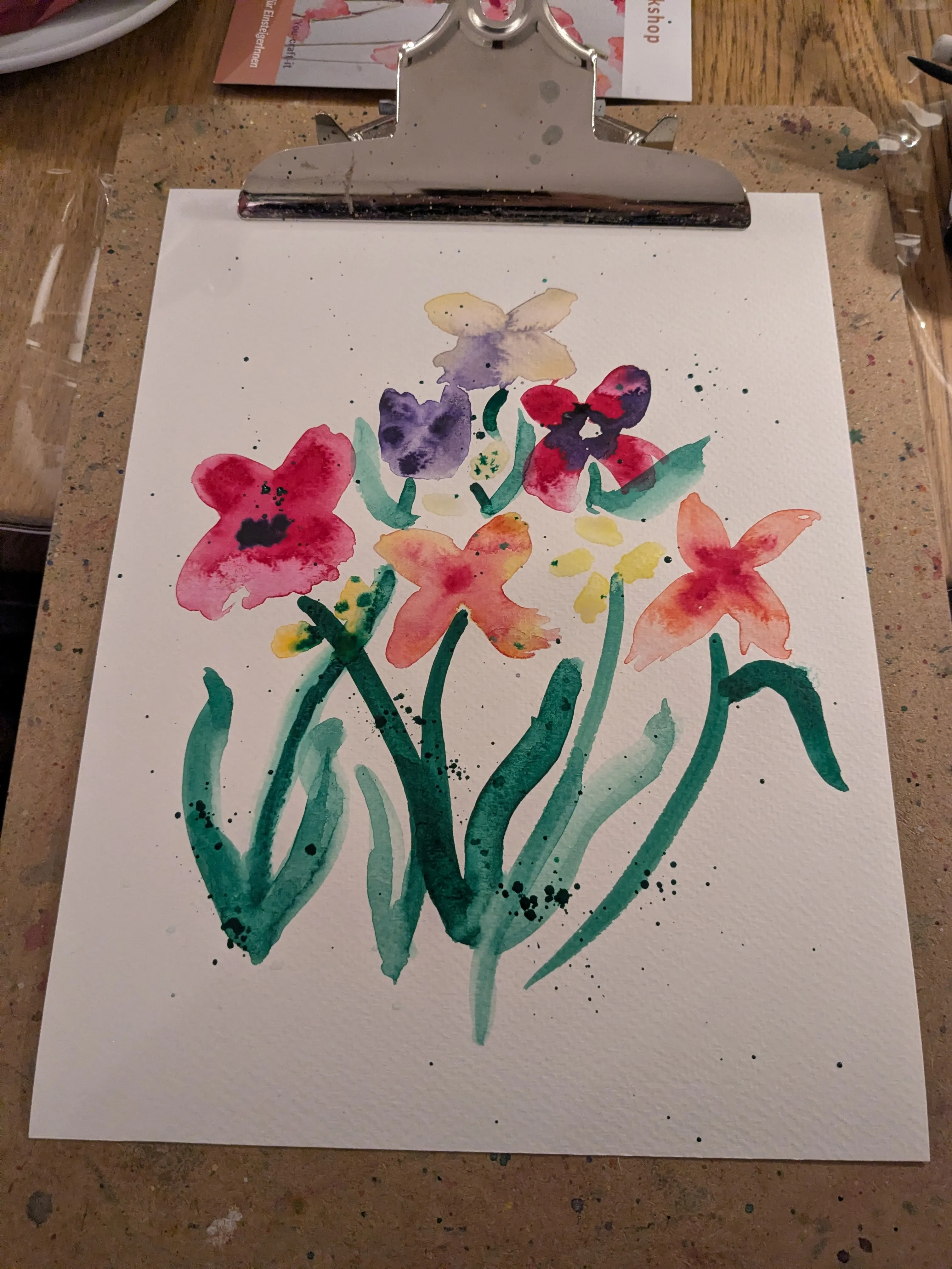 Watercolor painting of flowers on table.