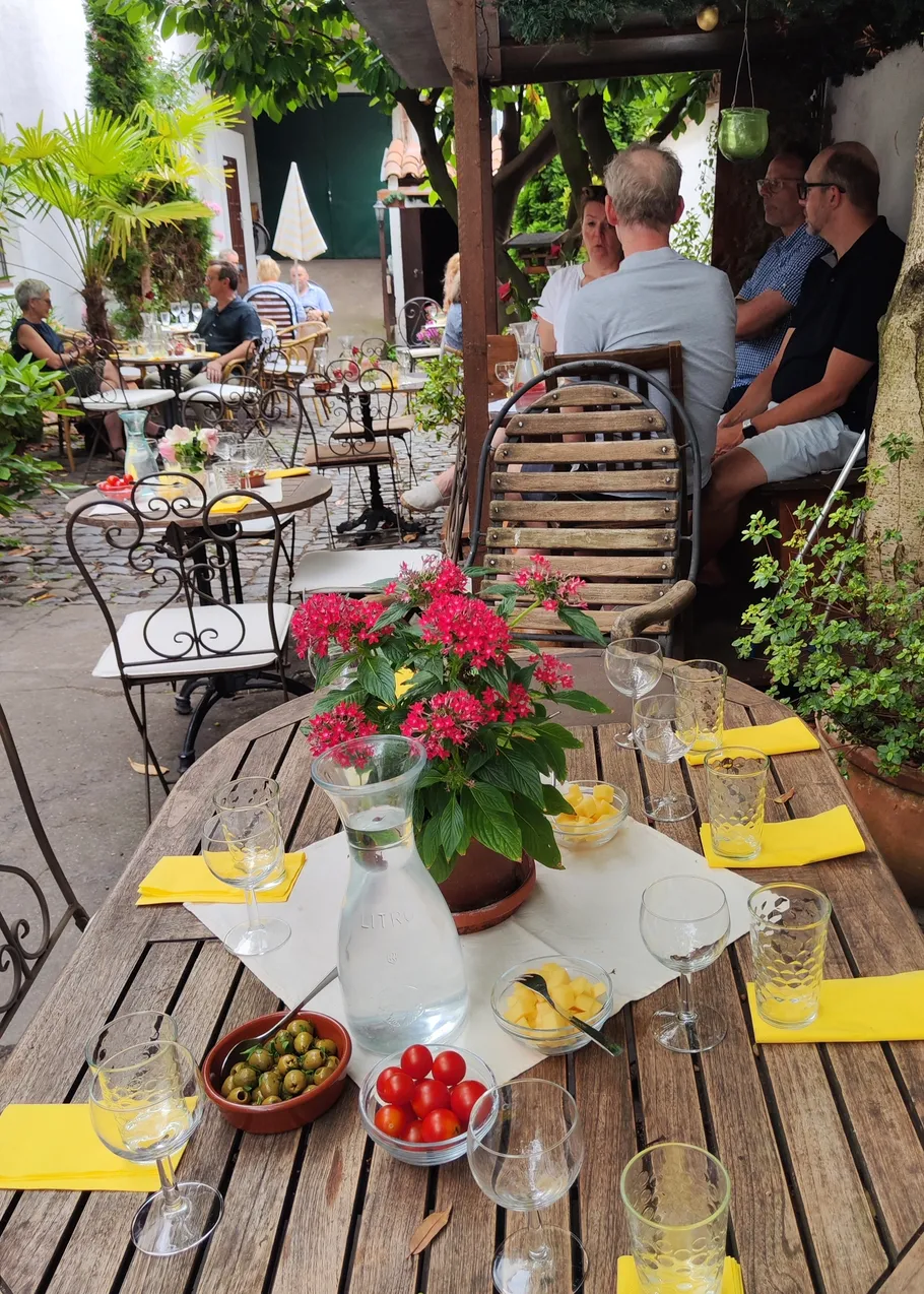 Outdoor café with tables and people dining.