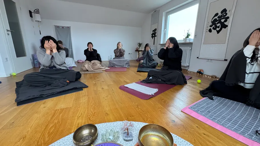 People meditating on floor in room.