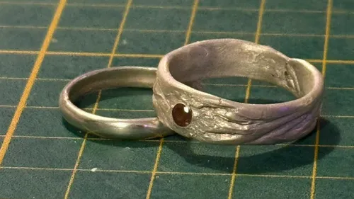 Two metal rings on a green grid.