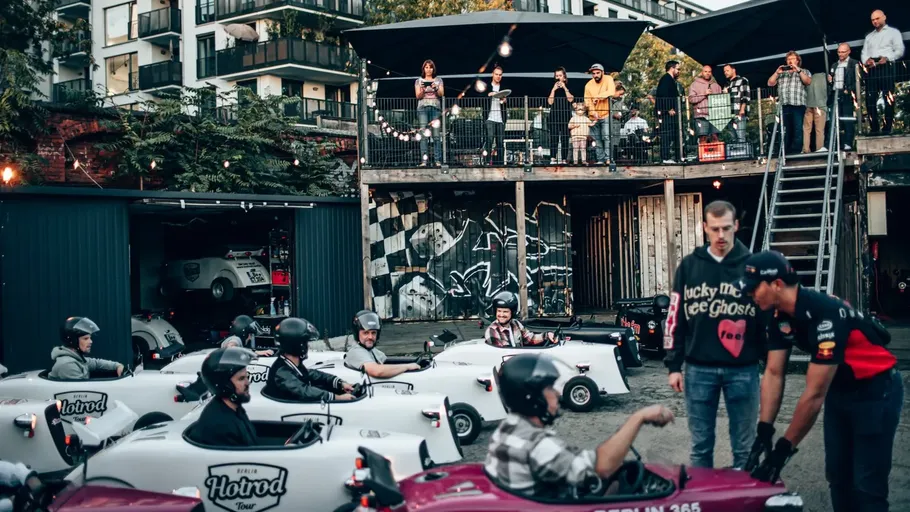 Mini cars driving in urban gathering area.