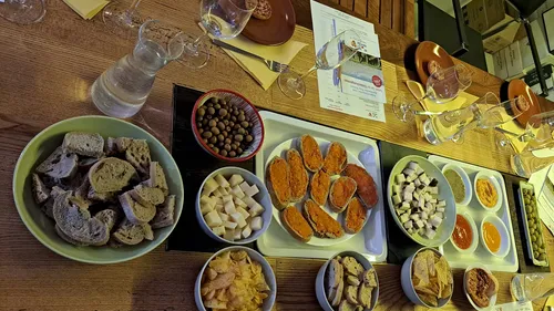Assorted appetizers and bread on wooden table.