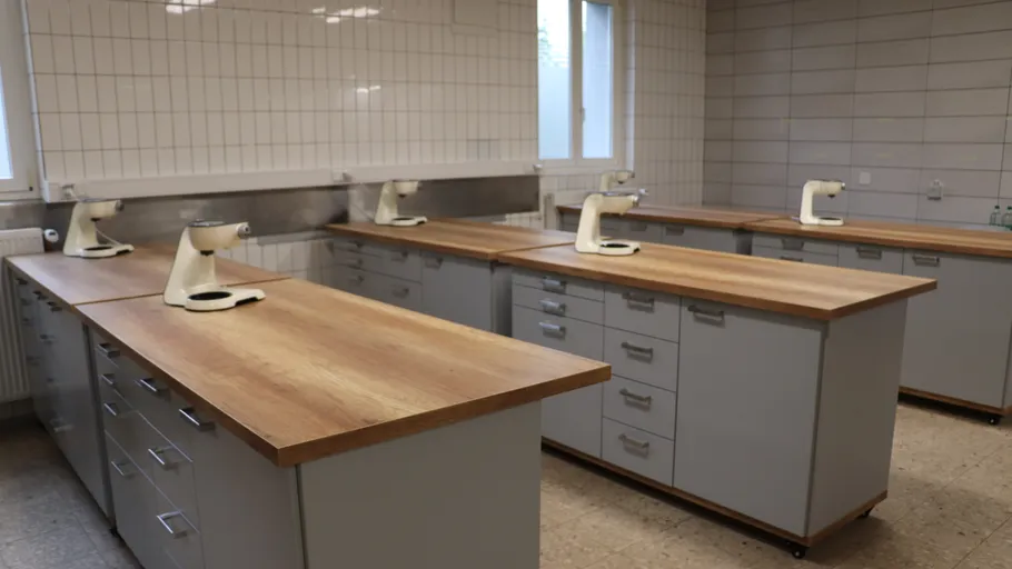 Laboratory with benches and microscopes present.