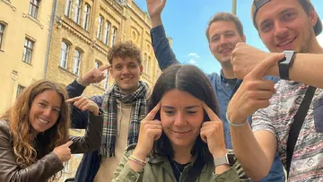 Group of people posing in urban environment.