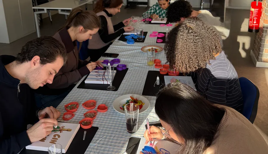 People decorating cookies at a table.