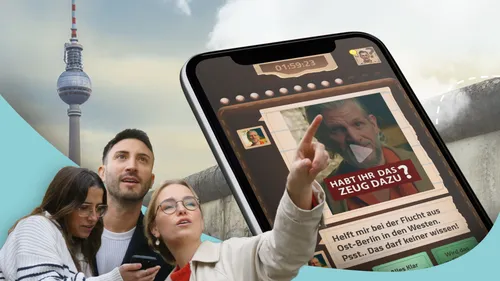 People looking at app, Berlin TV Tower.