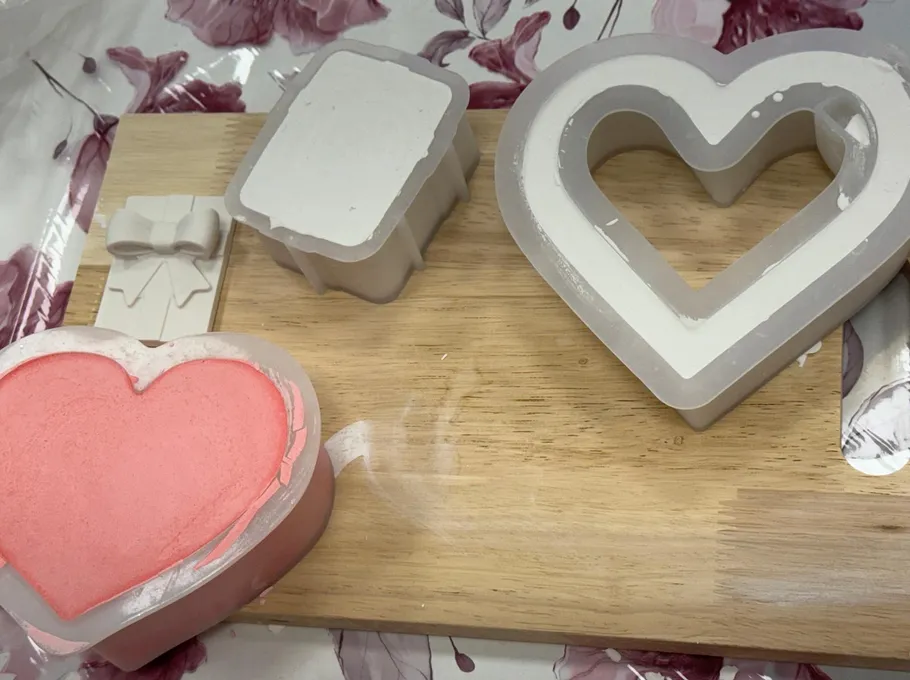 Silicone molds on a wooden board.