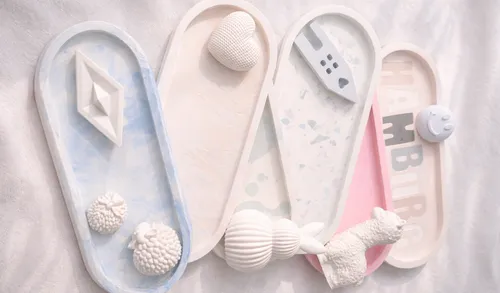 Ceramic trays with decorative white objects.