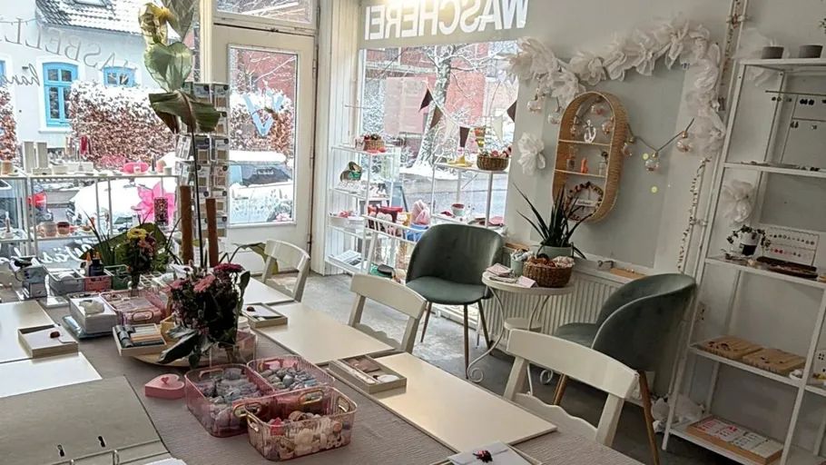 Cozy craft shop with tables and decorations.