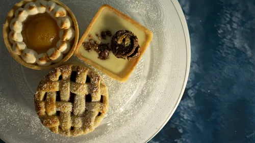 Three small pastries on a white plate.