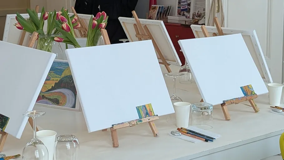 Blank canvases on easels in art studio.