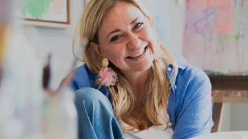 Woman smiling in art studio.