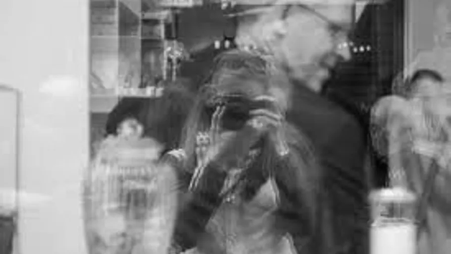 Blurred reflection of photographer taking photo.