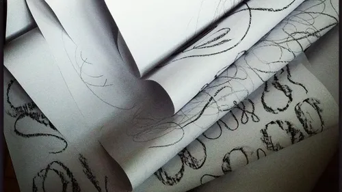 Rolls of paper with black scribbles.