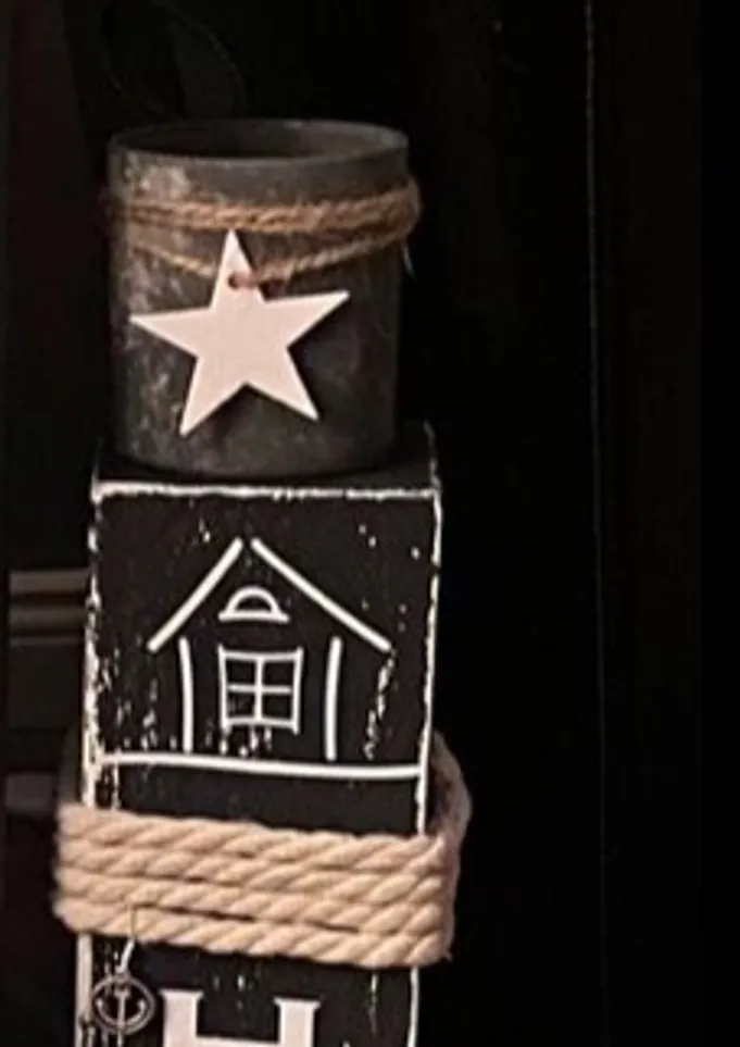 Decorative candleholder with star and rope.