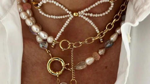 Layered necklaces with pearls and gold chains.