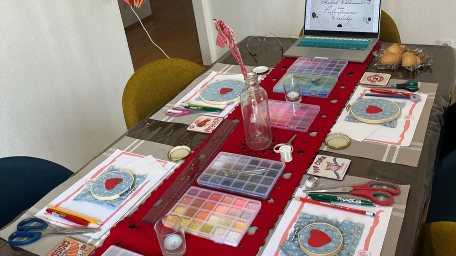 Craft table with embroidery supplies organized.