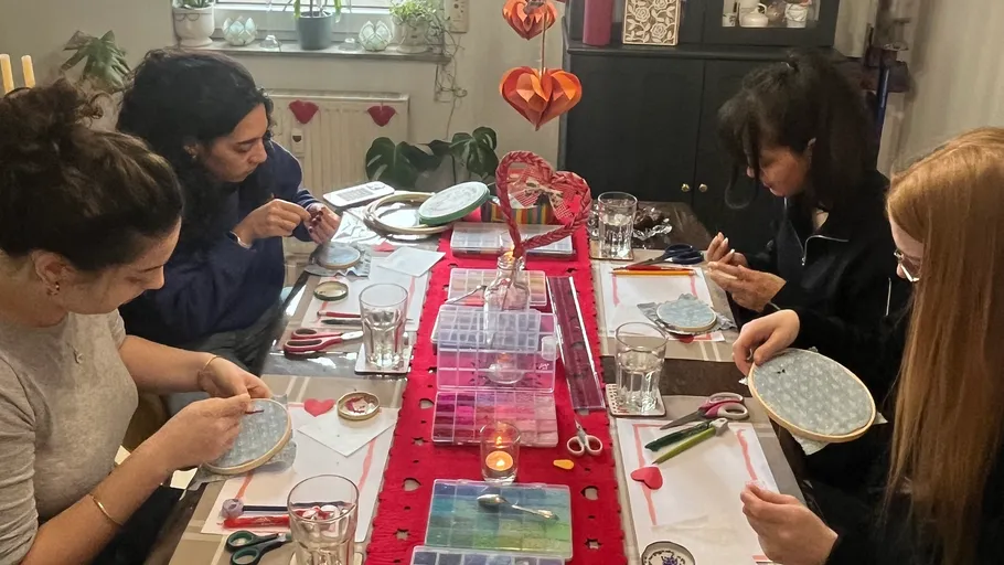 Four women doing crafts at a table.