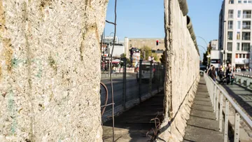 Berlin Wall remains with city street view.