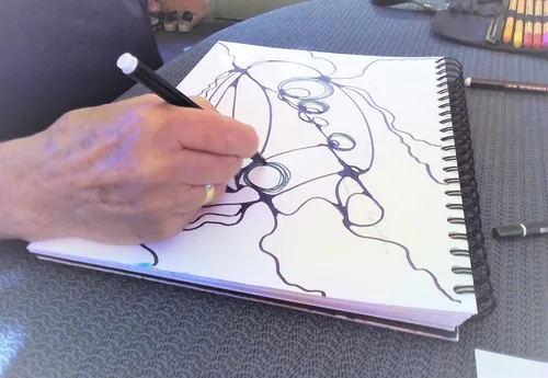 Hand drawing abstract art in sketchbook.