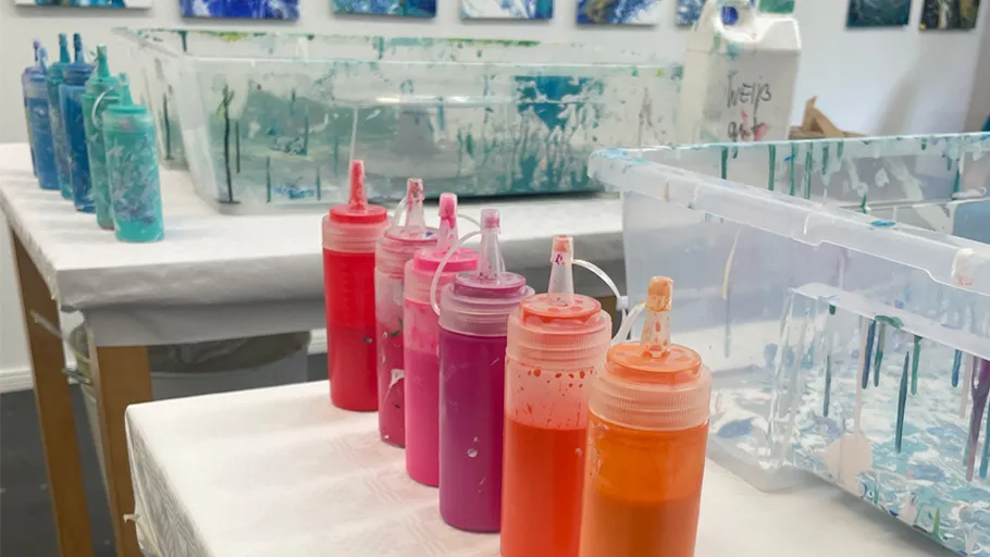 Colorful paint bottles in art studio.