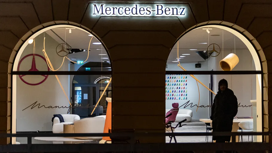 Schaufenster bei Nacht mit Mercedes-Benz-Schild.