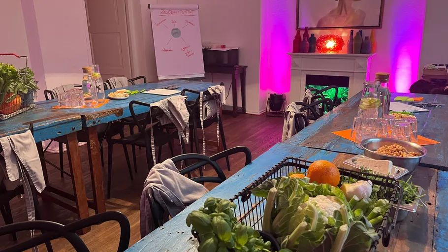 Rustic kitchen setup with vegetables on tables.