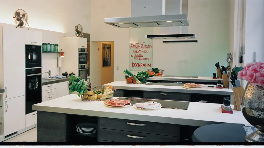 Modern kitchen with cooking island and decor.