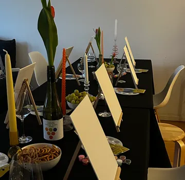 Canvases and snacks on a dining table.