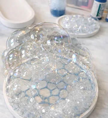 Soap bubbles sitting on a white plate.