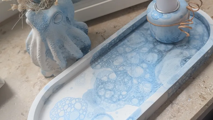 Tray with blue bubbles beside ceramic octopus.