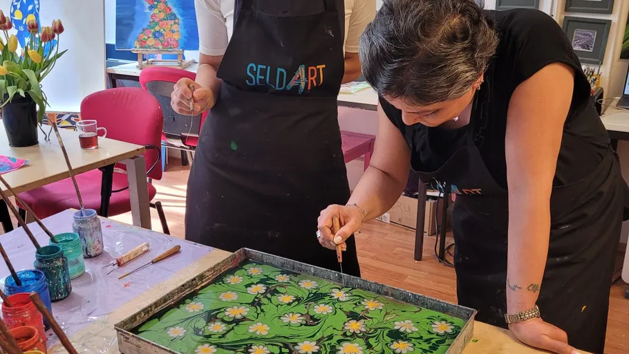 Two people creating art in a studio.