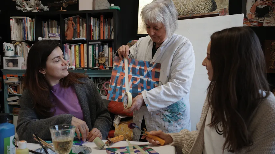 Three women crafting in an art studio.