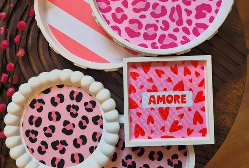 Decorative coasters with pink patterns on table.