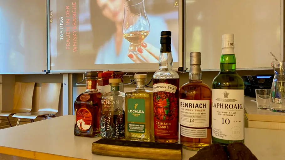Whiskey bottles displayed on a table in classroom.