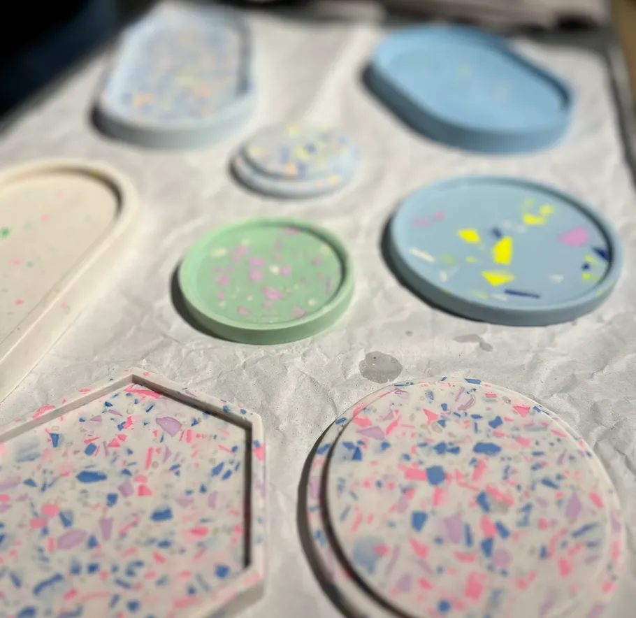 Colorful terrazzo coasters on white fabric.