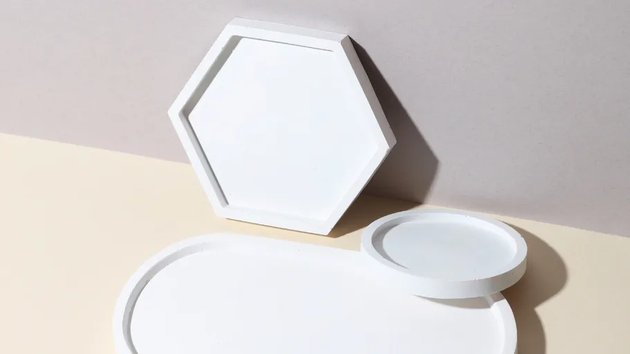 White trays in hexagonal and round shapes.