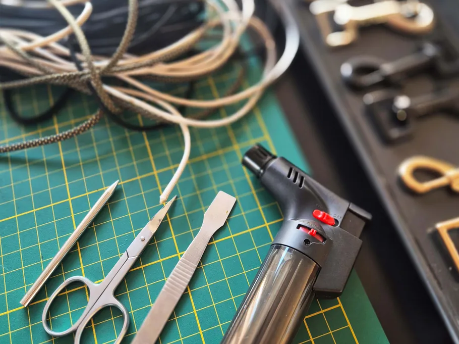 Tools and cord on green cutting mat.