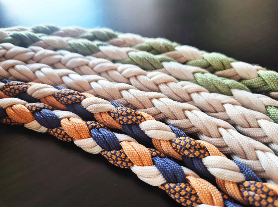 Colorful braided ropes, resting on a surface.
