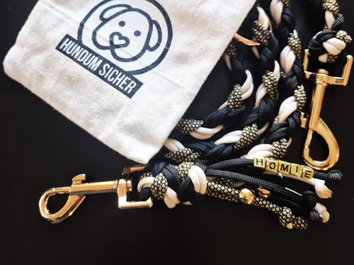 Dog leash and bag with logo on table.