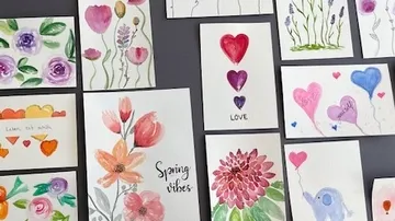 Colorful handmade cards displayed on gray surface.