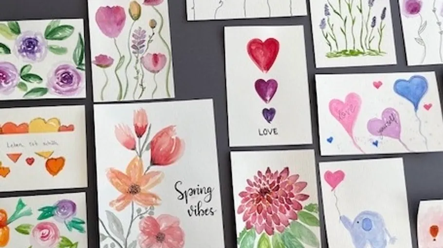 Colorful handmade cards displayed on gray surface.