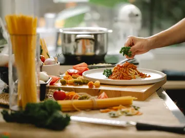 Pasta is decorated with parsley in modern kitchens.