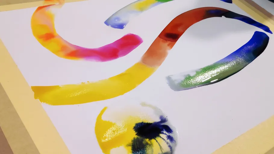 Colorful paint streaks on white paper.