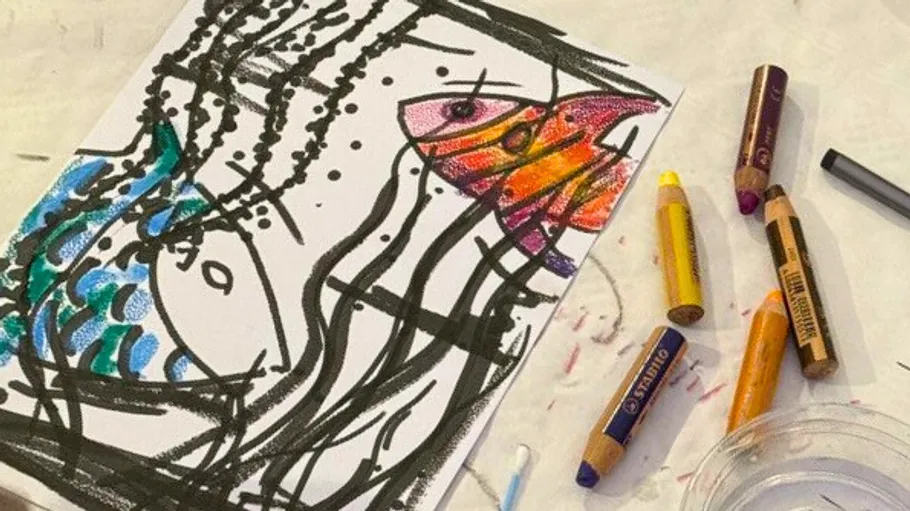 Crayon drawing of abstract fish scene.