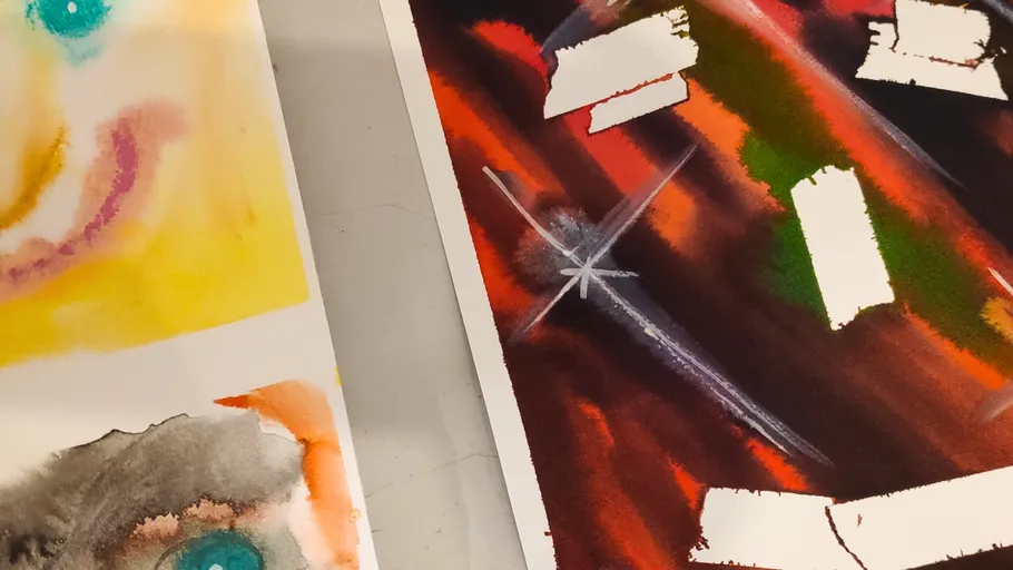 Abstract watercolor paintings on a flat surface.