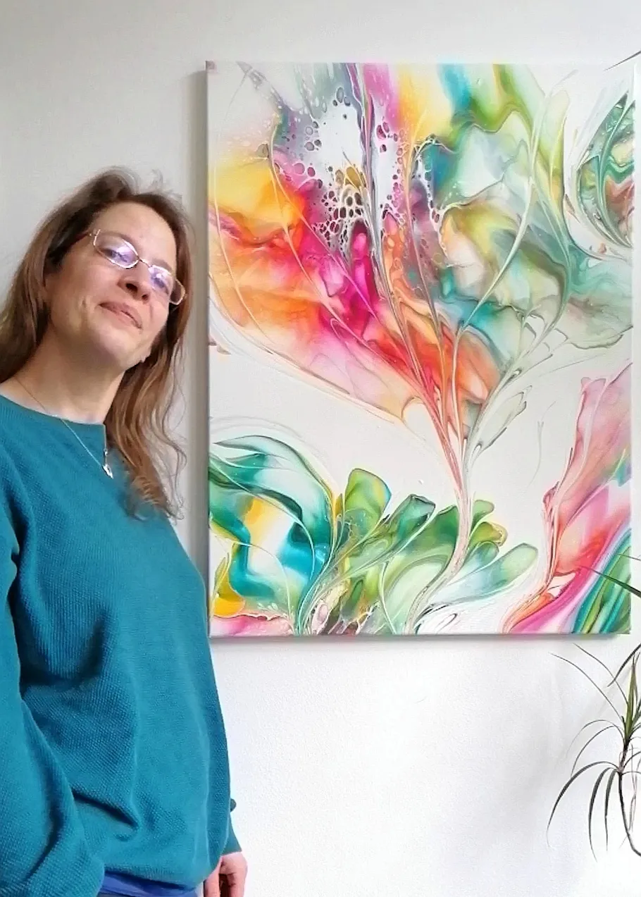 Woman posing next to colorful abstract painting.