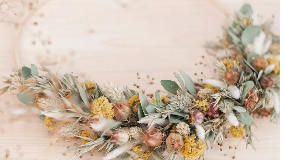 Dried floral wreath on a wooden surface.