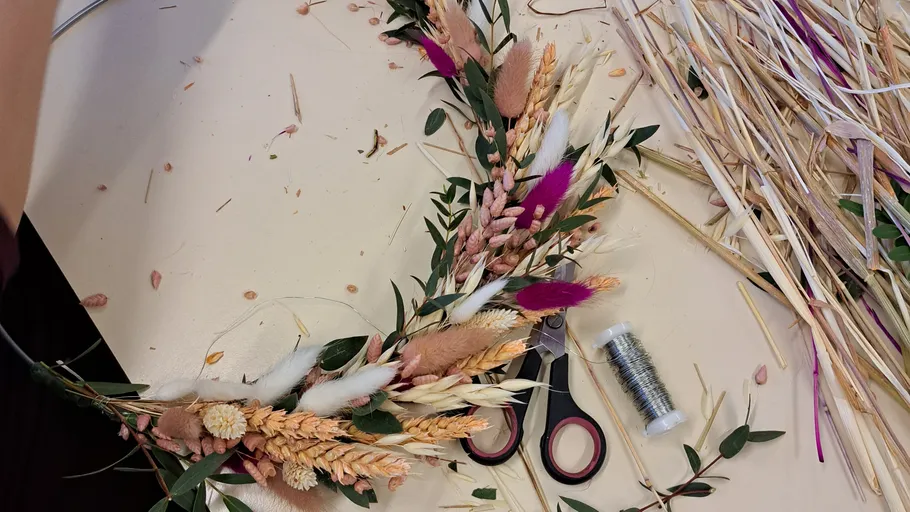 Dried floral arrangement on a crafting table.