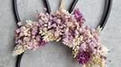 Floral headbands with purple flowers on display.
